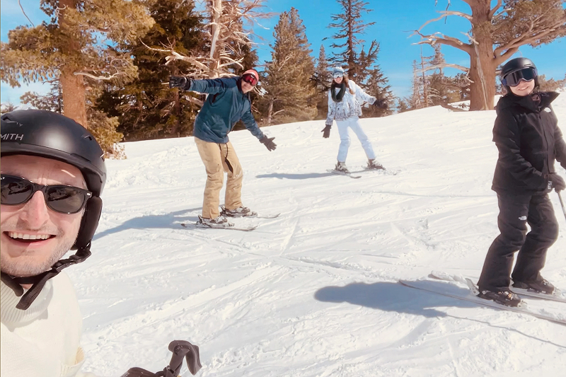 Digital Foundry Software Consultants and family smile while skiing down a hill