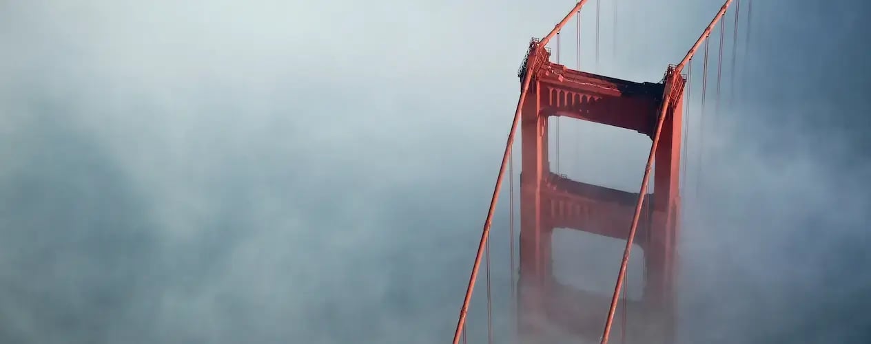 High-angle Aerial photo of the Golden Gate Bridge in the San Francisco Bay Area, with fog