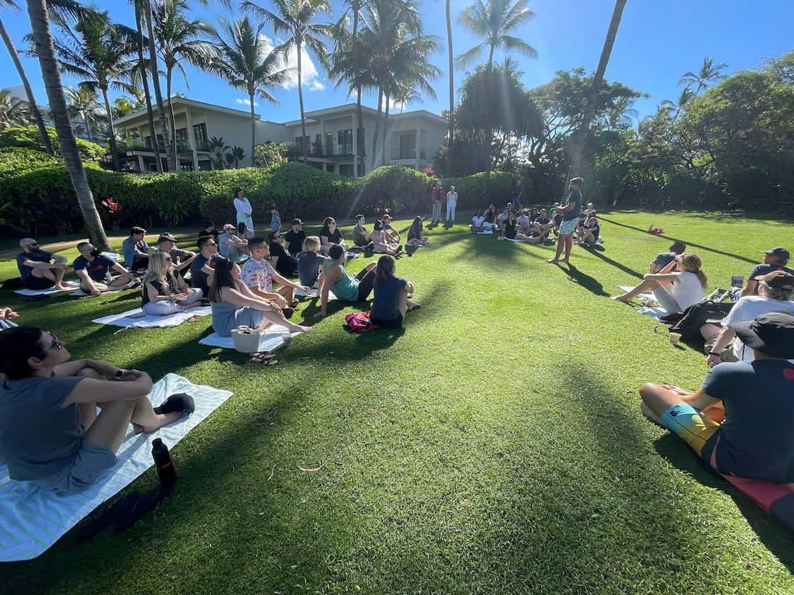 Company meeting on a lush Maui lawn