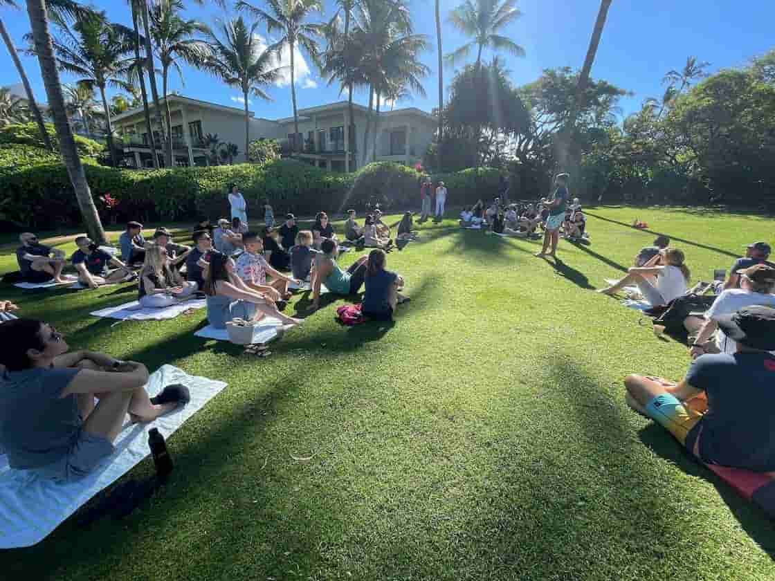 Company meeting on a lush Maui lawn.